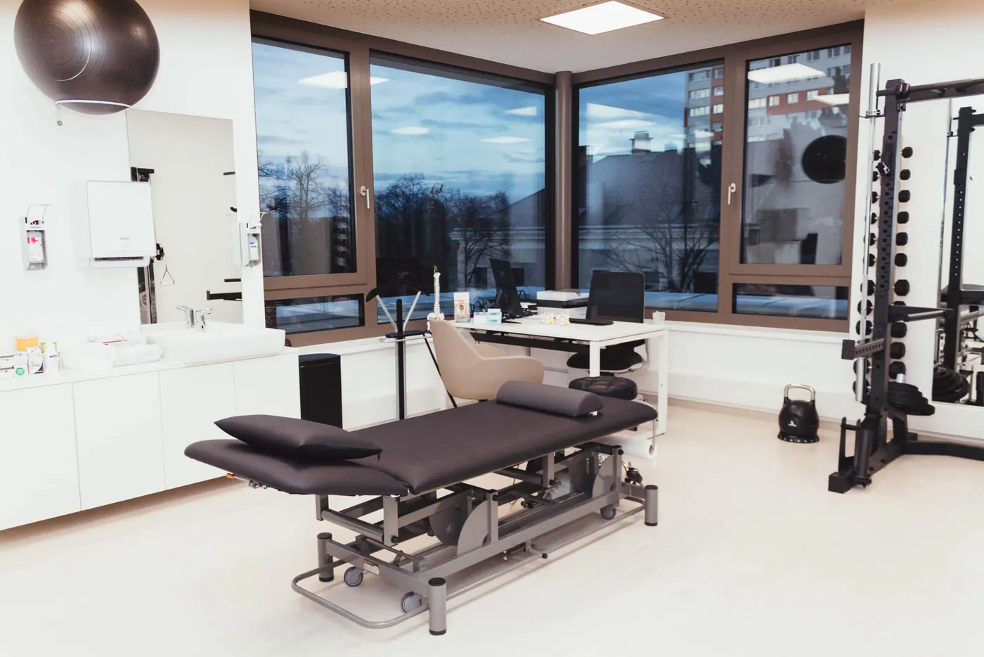 Behandlungsraum mit Liege und Trainingsgeräten